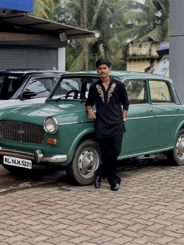 A-boy-standing-in-front-car